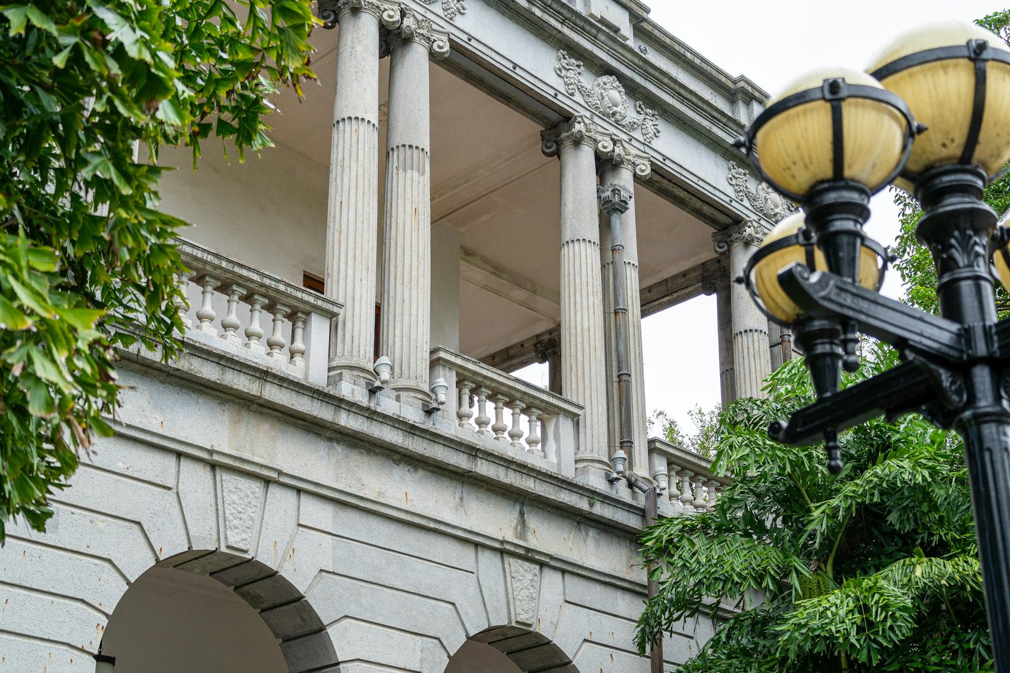 Classical columns and ornate stonework with a lamp post